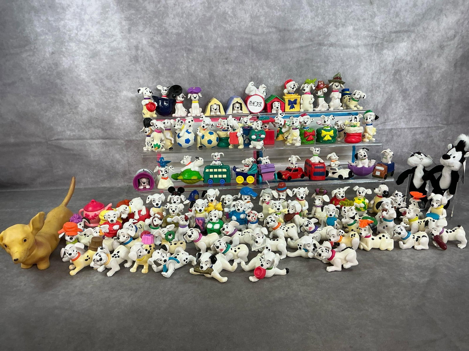 Disney 101 Dalmatians Figures & More: 101 collectible "101 Dalmatians " Happy Meal figures, two Looney Tunes skunks and a squeeze dachshund toy from late 1900's. McDonald's hard plastic toy dogs from Disney movie. Pepe and Penelope
