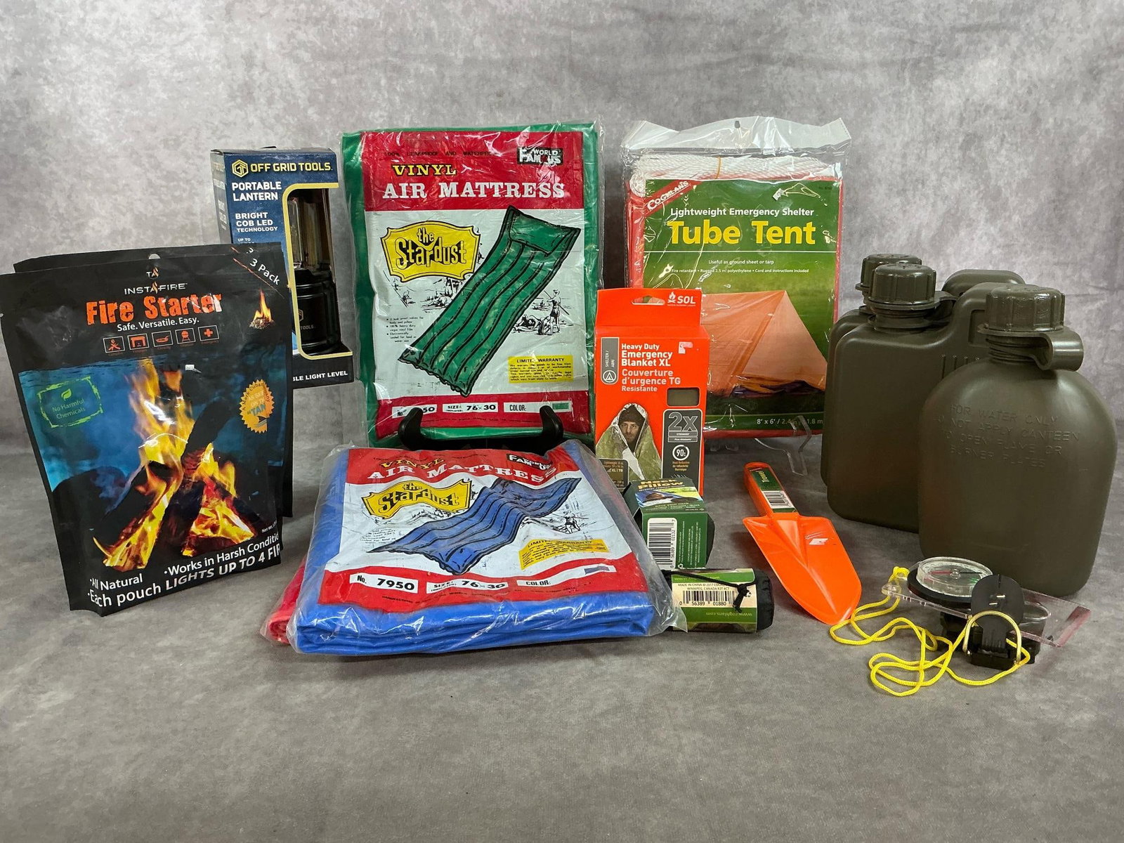 Camping Gear: Fifteen new camping items. Three vinyl air mattresses, emergency tube tent, three plastic canteens, two bags of fire starters, portable lantern, and more. In original packaging. Air mattresses