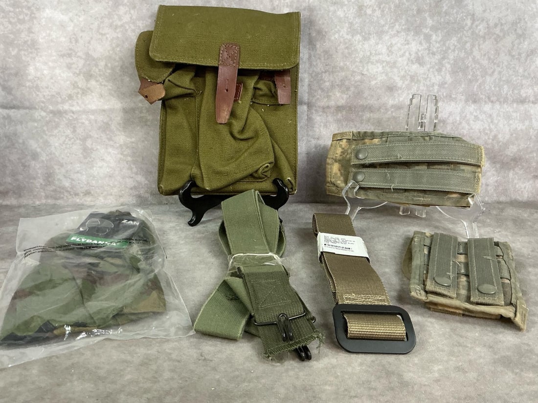 Military Surplus: Six military new and used items. Military magazine canvas pouch, cotton Flydanna headgear, and two double magazine pouches. Also, G I pants suspenders and size 34 tan belt. Large canvas pouch