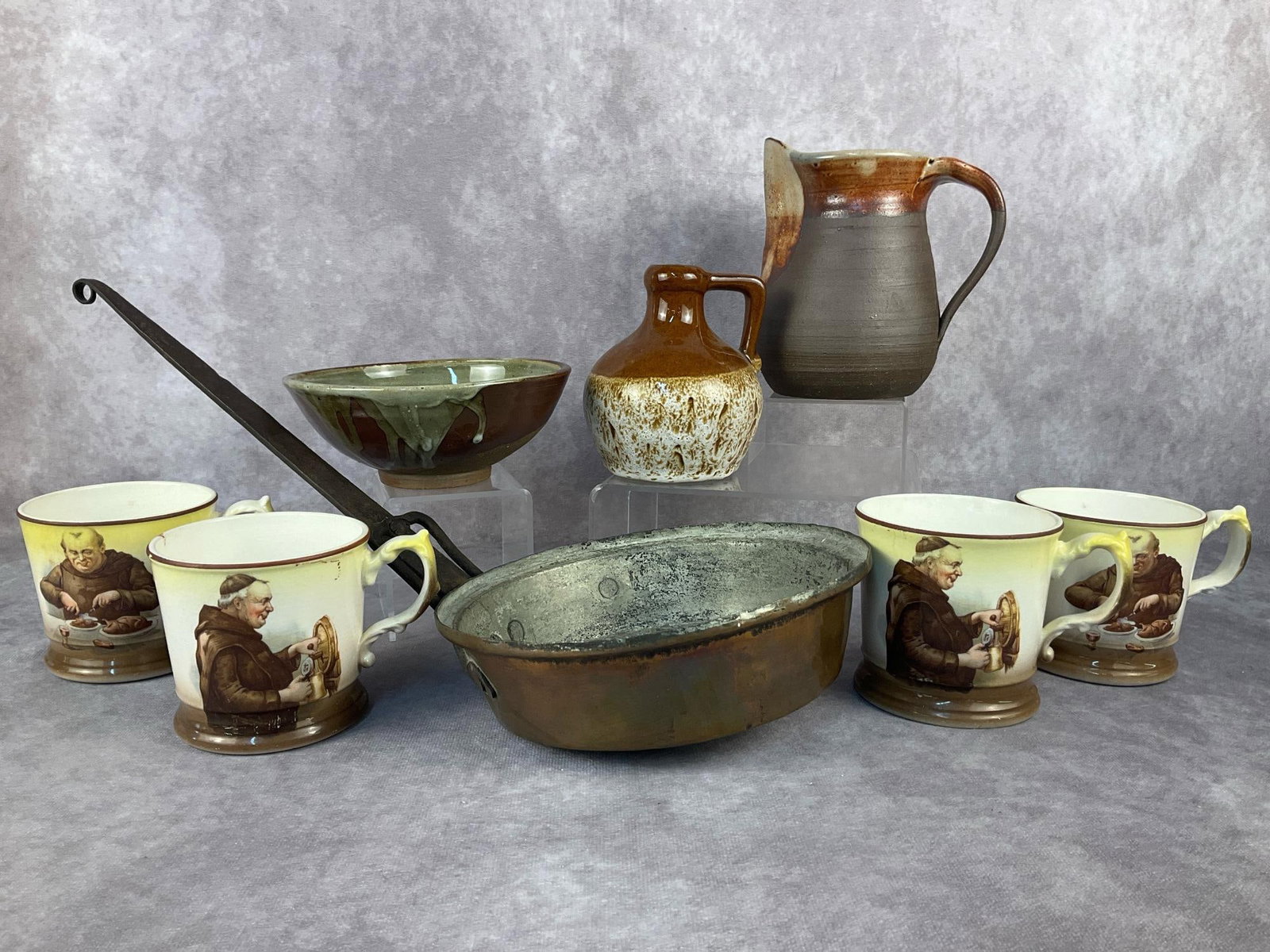 Studio Pottery & More: Eight vintage kitchen items. Lot includes a Fat Lava pottery vase, a handmade pottery pitcher, four Friar Tuck Monk Ware cups, a handmade pottery bowl and a hammered copper pan. Pitcher measures 5.5