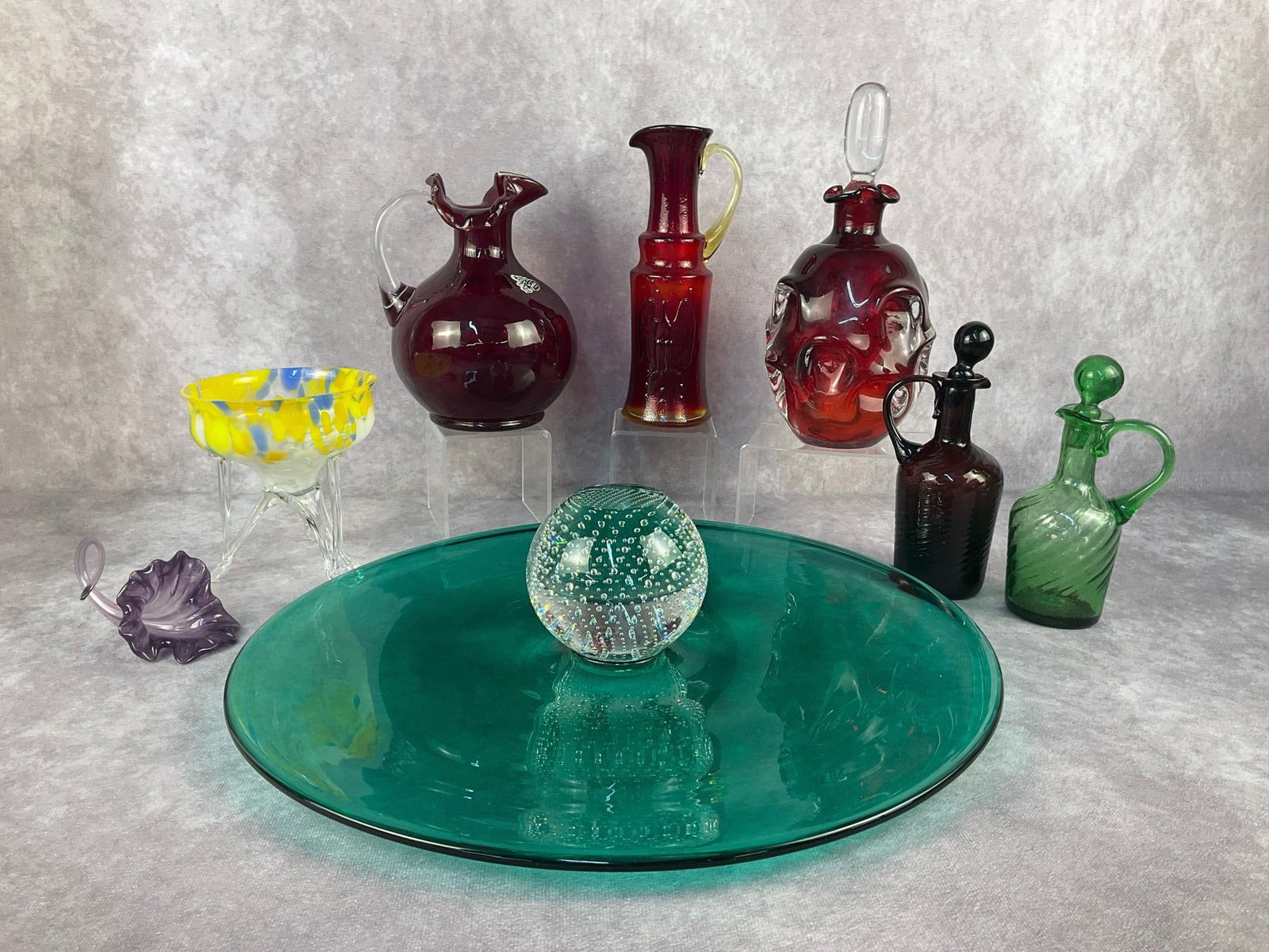 Art Glass & More: Nine vintage decorative glass items. Includes a Fenton Ruby Red Thumb Print Coin Dot Pitcher, Kanawha Amberina American Eagle Pitcher, Bo Borgstrom for Aseda Ruby Red decanter, two swirl pattern