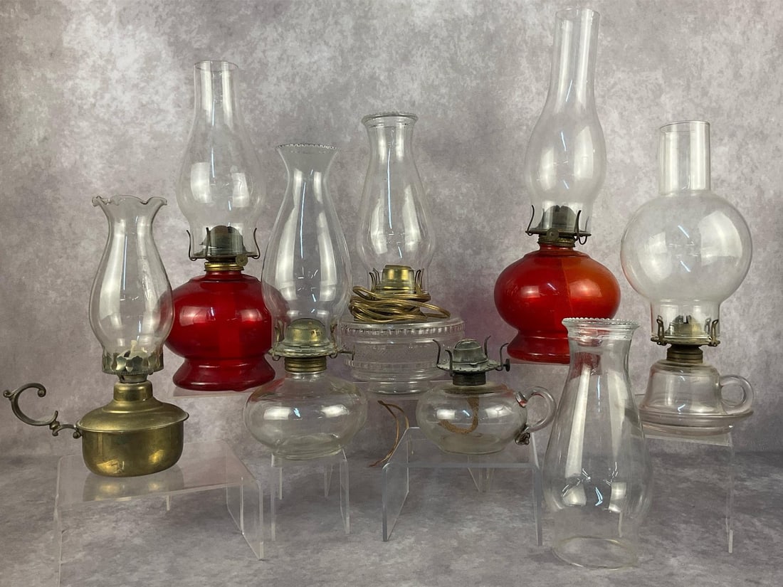Oil & Kerosene Lamps: Seven vintage oil/kerosene lamps with chimneys. One was converted into electric but is missing the attachment plug. Normal signs of rust and wear are present and one of the chimney shades has a small