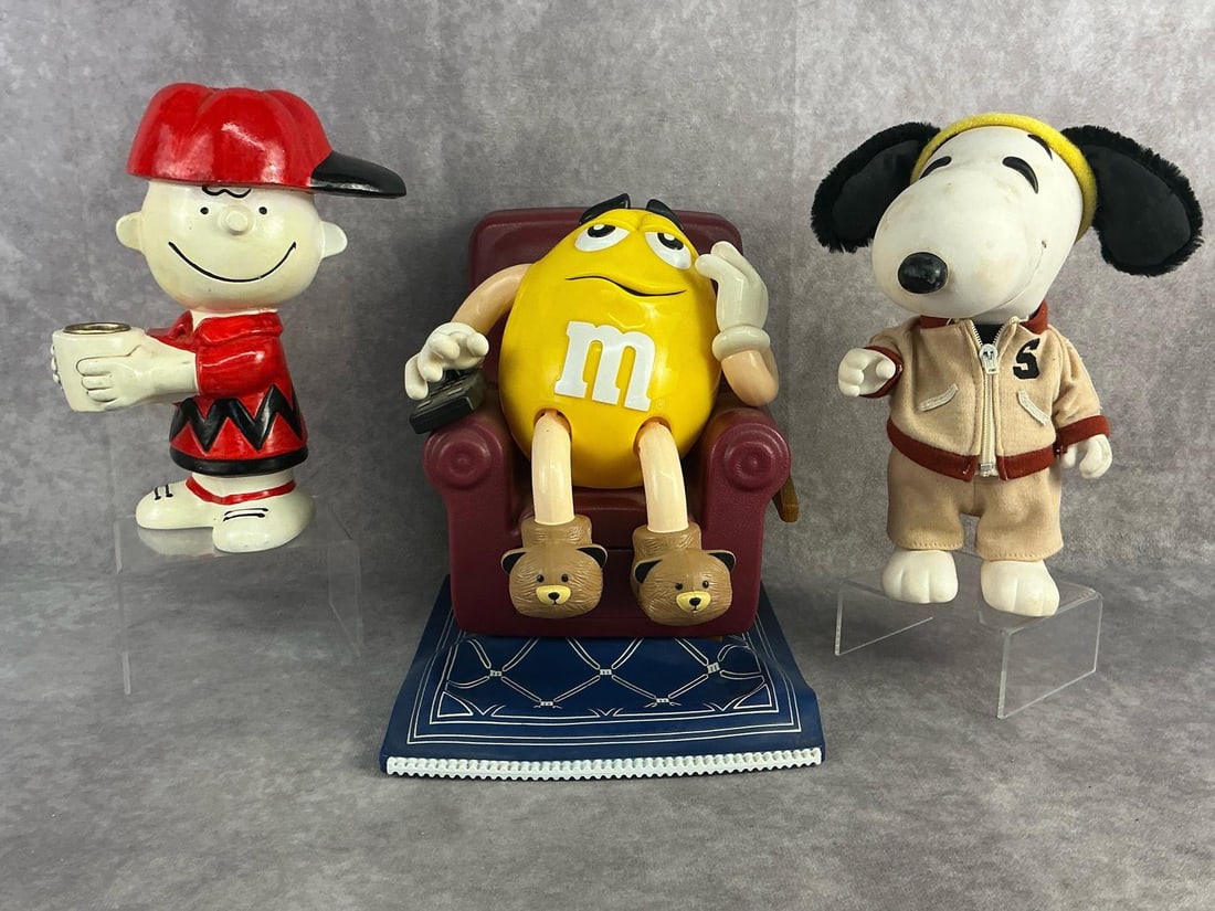 Snoopy & More: 1958 Exercise Snoopy, taper candle holder of Charlie Brown, and M&M candy dispenser. All in good condition. M&M measures 7 inches wide x 8 inches tall.