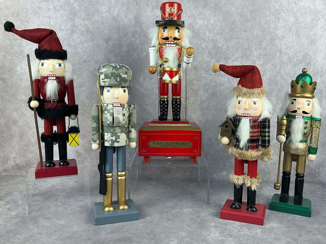 Nutcracker Collection: Five modern wooden nutcrackers. Includes a FAO Schwatz musical nutcracker. Tested and works. In good condition. Musical Nutcracker measures 4.5 inches wide x 4 x 12 inches tall.