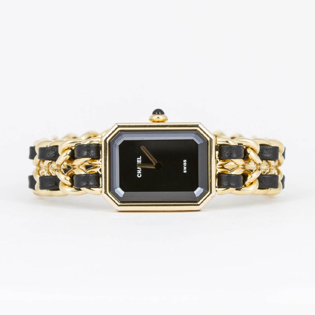 Chanel Premiere: Chanel Premiere M in Black/Yellow Gold Plated. Gold tone with black interlaced leather Bracelet. Perfect condition. Black Dial. Dimensions Dial:18*24mm / Bracelet:16cm. Weight of 46,4g. Jewelry clasp