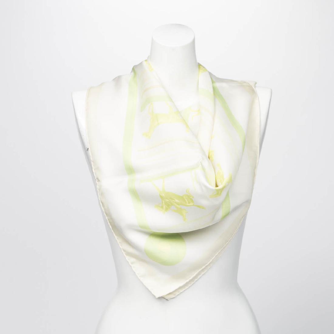 HERMES Scarf: HERMES Scarf in Ivory/Green. 1% Silk. Some Horses on this scarf. The "Hermes Paris" Signature is on the scarf. Few signs of wear on the scarf on the middle left side of the scarf. One small pen mark o