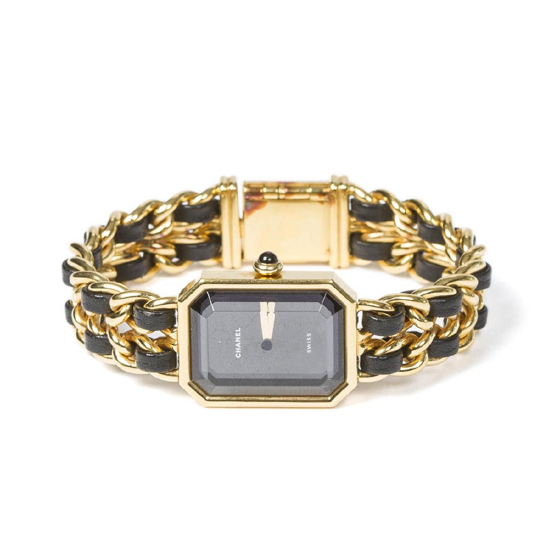 Chanel Premiere M size in Black/Yellow Gold Plated: Chanel Premiere M in Black/Yellow Gold Plated. Gold tone with Black interlaced leather Bracelet. Excellent condition. Black Dial. Dimensions Dial:20*25mm / Bracelet:14,5cm. Weight of 47,2g. Jewelry cl