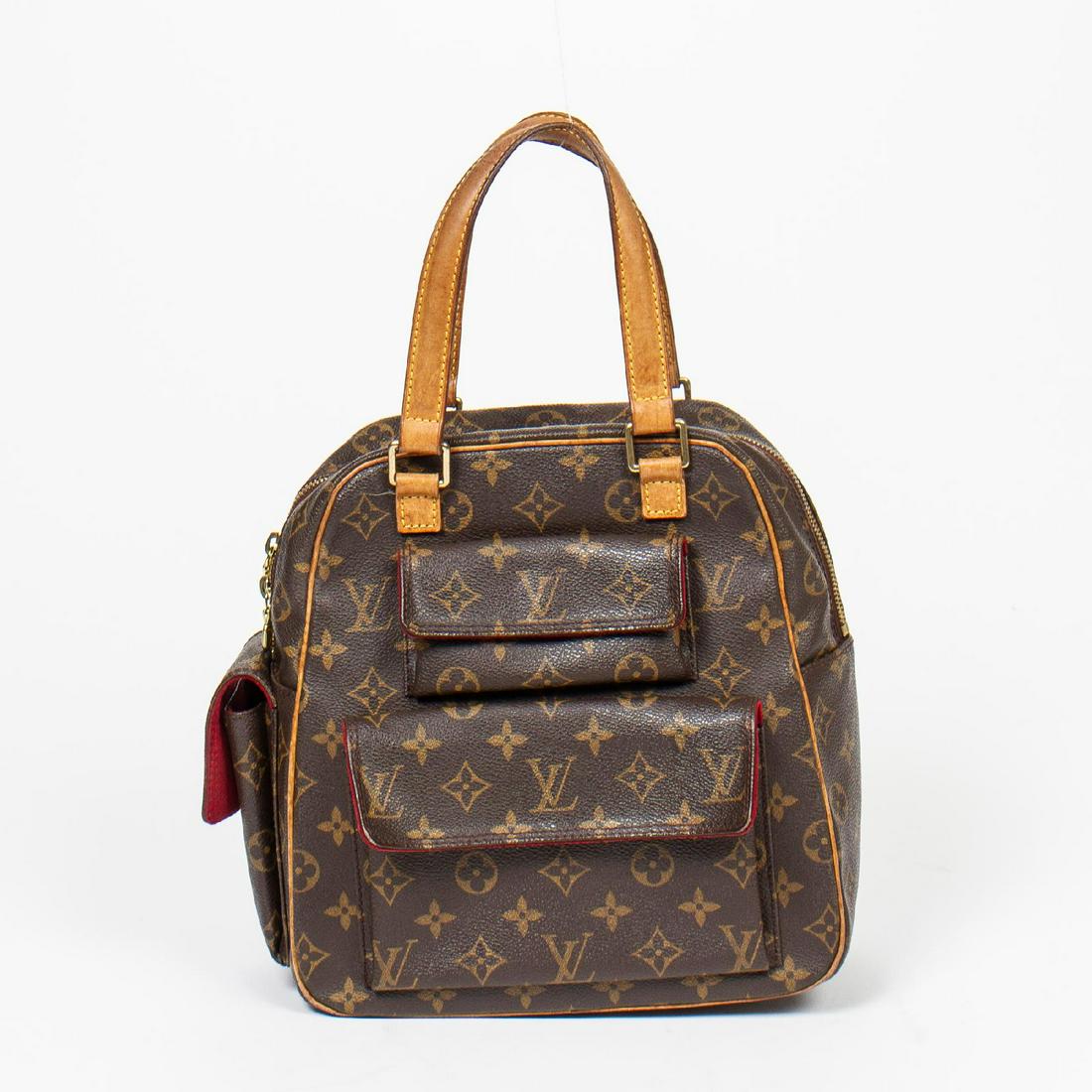 Louis Vuitton Excentri-Cite: Pre-loved Louis Vuitton Excentri-Cite in Brown coated Monogram Canvas with Vachetta leather handles. The hardware is in Golden Brass. Dimensions (L*H*D in cm): 24*26*12cm. Brand Production Code : Not 