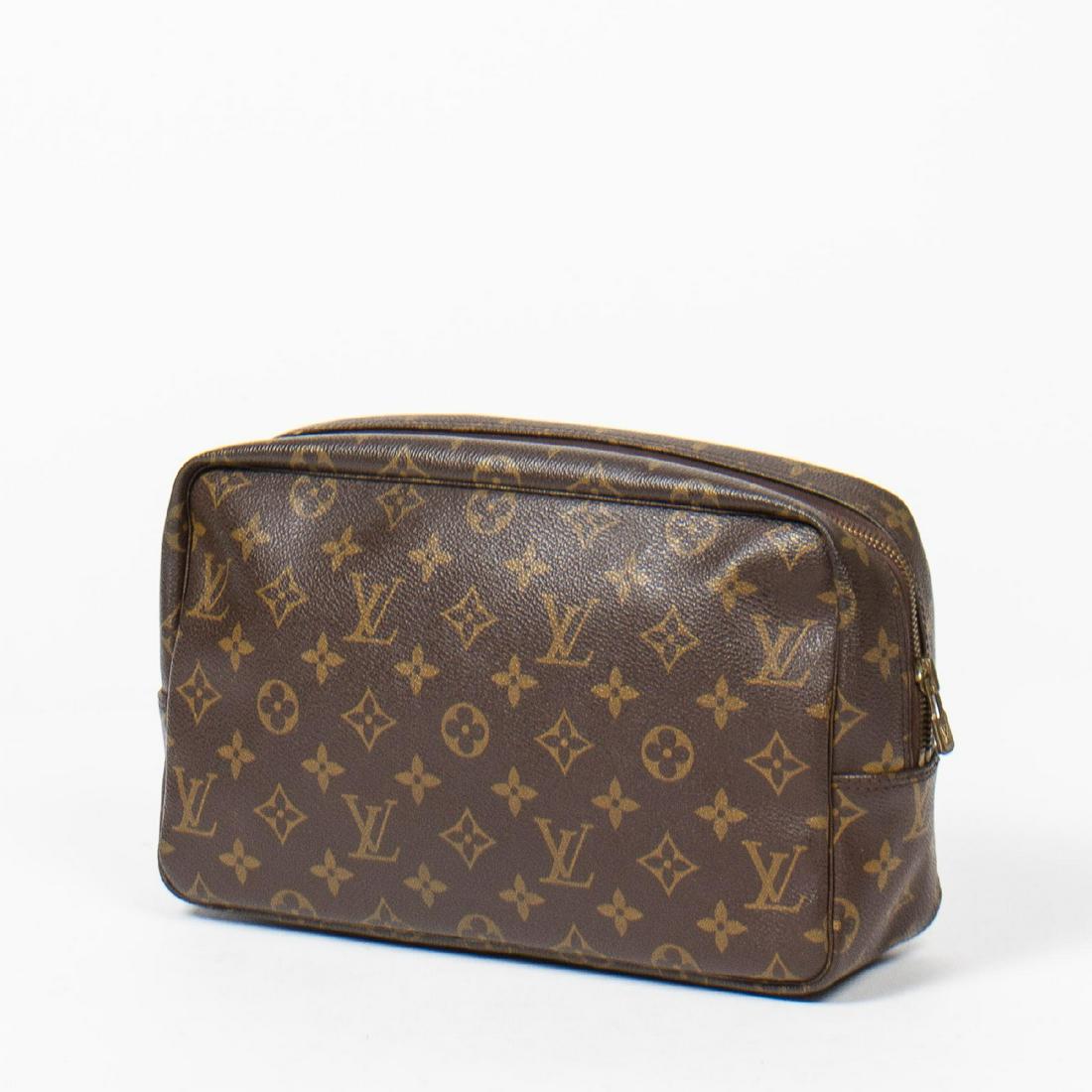 Louis Vuitton Toiletry Pouch GM: Pre-loved Louis Vuitton Toiletry Pouch GM in Brown coated Monogram Canvas. The hardware is in Golden Brass. Dimensions (L*H*D in cm): 27*16*7cm. Brand Production Code : NO0961. Very Good condition. Th