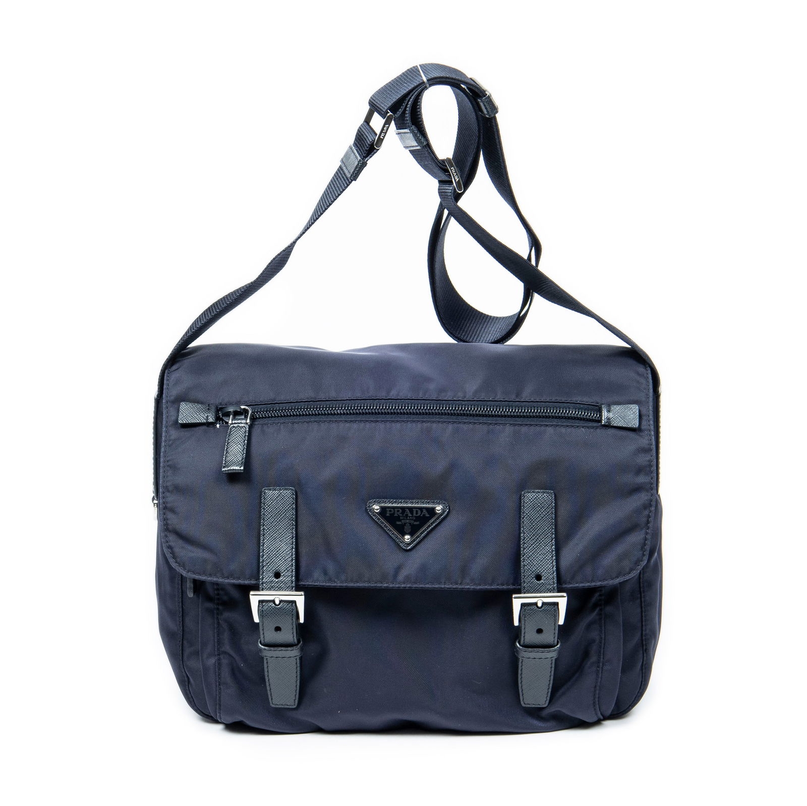 Prada Buckle Flap Messenger: Prada Buckle Flap Messenger in Navy Blue Nylon Canvas. Hardware is in Silver metal. Its dimensions are the following (L*H*D): 26*20*11cm. Production code: 158/B. We graded this item AA condition, as w