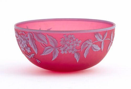 THOMAS WEBB & SONS Cameo glass bowl patterned with: THOMAS WEBB & SONS Cameo glass bowl patterned with trailing blossoms and butterfly in white on frosted ruby ground, ca. 1890. Stenciled signature. 5 1/4" dia