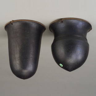 Two WILLIAM WYMAN stoneware hanging bask: Two WILLIAM WYMAN stoneware hanging baskets, one helmet-shaped and the other bullet-shaped, both covered in gunmetal glaze with original hanging wires. Small chips to rim of first one. Stamped WW. 10