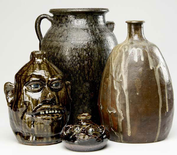 SOUTHERN POTTERY Four pieces: Lanier Meaders: NORTH CAROLINA POTTERY Four pieces: Lanier Meaders face jug; Mary Rogers face jug; large stoneware jug with loop handle; unidentified stoneware vase with white drip glaze. Meaders jug signed, Marie Ro