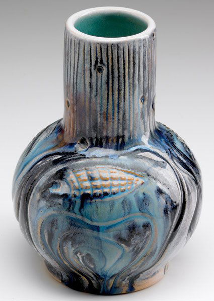 NORTH DAKOTA SCHOOL OF MINES Bottle-shaped vase: NORTH DAKOTA SCHOOL OF MINES Bottle-shaped vase with fish and tree-trunk pattern, covered in blue, white and black flambe glaze, the buff clay showing through. Indigo stamp. 7" x 5"