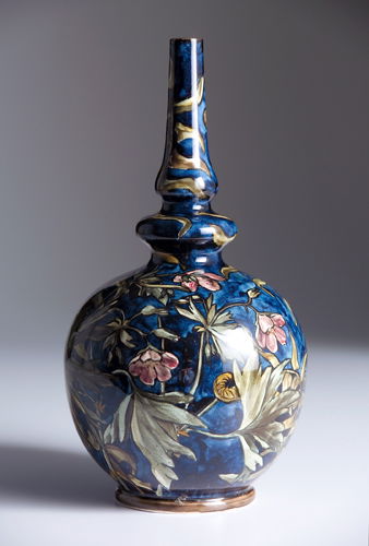 JOHN BENNETT Rare gourd-shaped vase painted with p: JOHN BENNETT Rare gourd-shaped vase painted with pink blossoms and green foliage on mottled cobalt ground. Signed J. BENNETT/ 101 LEX AVE/ N.Y./ cipher. 10 1/4" x 5 1/4"