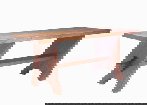 GUSTAV STICKLEY Small bench with trestle base, its: GUSTAV STICKLEY Small bench with trestle base, its broad lower stretcher mortised through the sides with accentuated mortise and keys. Dry original finish with light overcoat, some wear to top. Decal