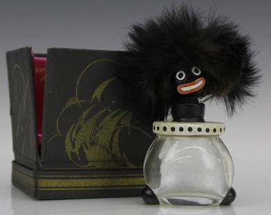 1920's Vigny Golliwogg Glass Perfume Sent Bottle w/ Box: 1920's Vigny Golliwogg perfume bottle. Modeled having a golliwogg head stopper with dimensional and painted characteristic features with black hair, painted eyes and lips and ball feet. Nicely housed