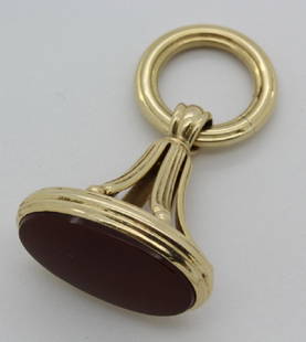 14k Gold Victorian Seal Pocket Watch Fob Charm Pendant: Antique 14k gold and carnelian fob pendant. Crafted of solid 14k yellow gold. Features an oval panel of carnelian. Measures 1.5" x 1". Tested 14k. Good condition some scuffs. Weighs 8.7 grams. In hous