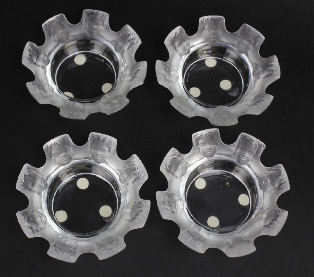 Set 4 Lalique Fine French Crystal St. Nicholas Ashtrays: Set of four Lalique ashtray dishes. Crafted out of fine quality polished and frosted French Crystal. Saint Nicholas pattern features faces of Cherubs along a crenulated top rim. Signed Lalique France 