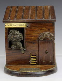 Antique French Dog House Tobacco Cigarette Serving Box: Crafted of hardwood in a medium finish. Features a lever pull action which opens the top and match door. Opens to reveal slotted holders for cigarettes. Dog with aviator style goggles peers out of a