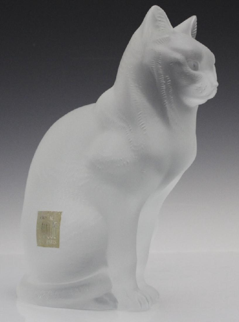 LALIQUE French Crystal Sitting Cat Glass Figurine: Crafted of fine quality French art glass with a frosted finish. Features a cool cat in a seated position. Signed Lalique France on bottom. Retains the original label. Measures 8 1/4" x 6" Very good co
