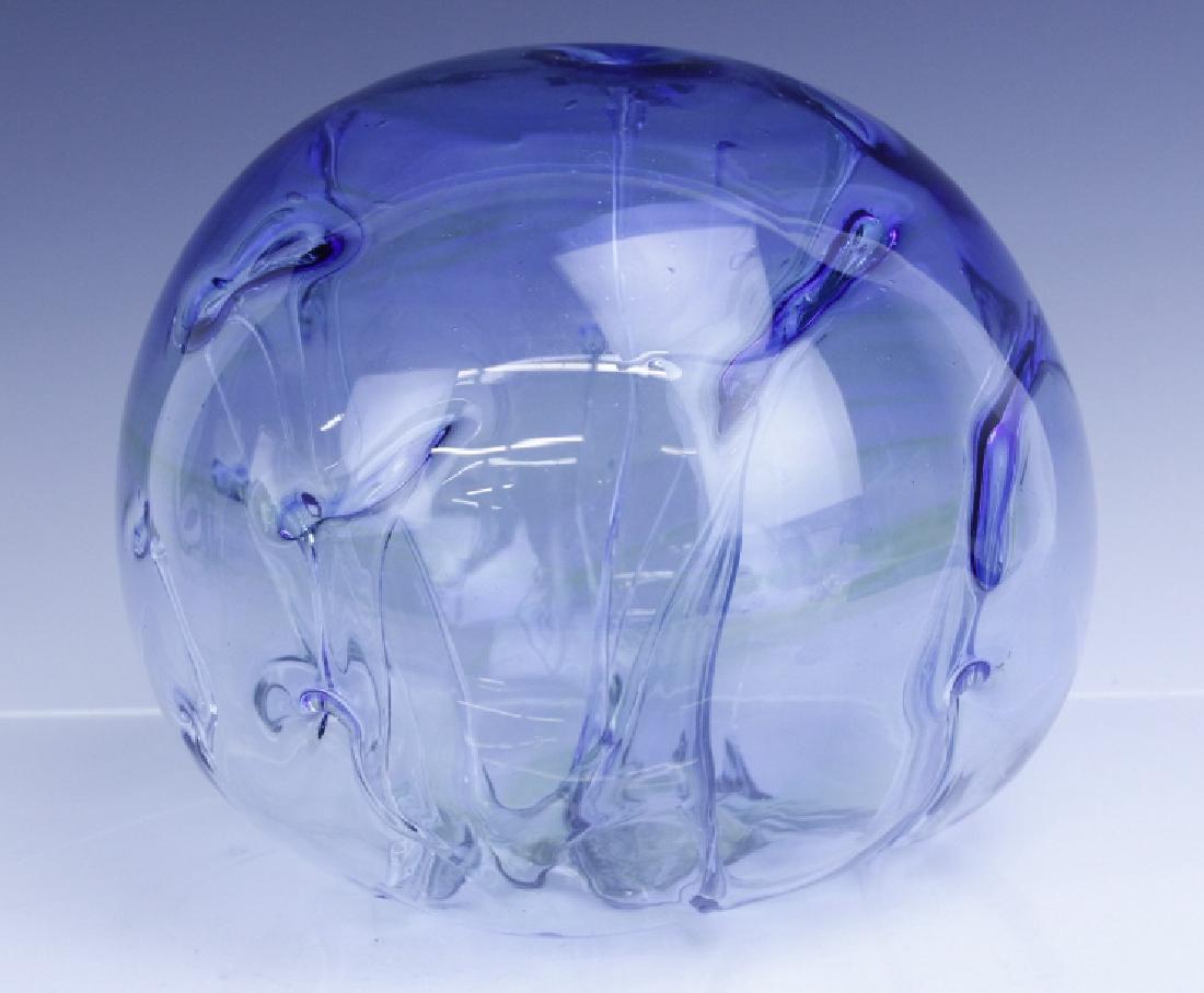 Signed PETER BRAMHALL Art Glass Blue Orb Sculpture: Crafted of hand blown studio art glass. Wonderful ice blue with yellow streaked bottom. Features modernist design with stalactite cave type center. Signed Bramhall dated 7/9/80. Measures 6 1/2" x 9".