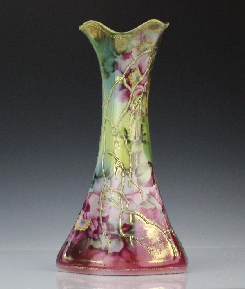 Floral Nippon Tapered Vase w/ Scalloped Neck: Antique Nippon vase. Crafted of fine Japanese porcelain with a tapered body and a scalloped neck. The vase is covered in raised moriage, and floral painted decoration. Measures 10.75" x 6". Condition 
