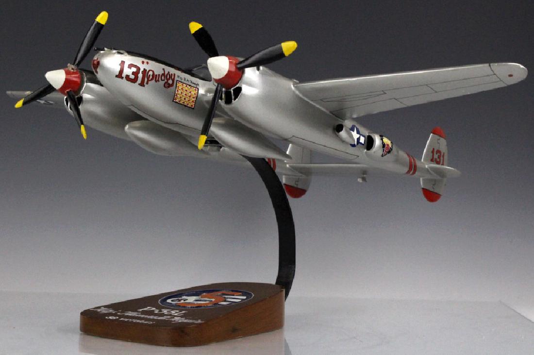P-38L Major Thomas B. McGuire Pudgy Aircraft Model: Collectors model plane. Aircraft model P-38L. Crafted from kiln dried hard wood. Paint scheme, markings and parts are closely matched, reflecting the original. Comes with fitted rotating stand. Marked