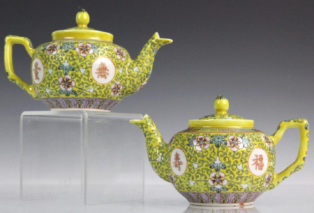 Pair Chinese Export Porcelain Famille Jaune Teapot: Imperial yellow ground with floral scrolling. Features reserves with prosperous symbols. Signed with a six character Guangxu style mark. Each measures 3 3/4" x 6" Good condition with mild surface wear