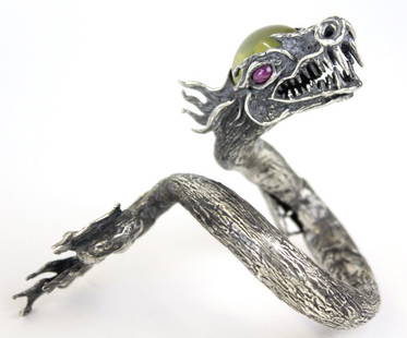 Studio Art Jewelry Sterling Silver Dragon Bracelet: Crafted of sterling silver. Features a highly detailed fierce dragon in hinged bangle style. Set with a large yellow moonstone cabochon gemstone as well as a smoky quartz round faceted stone. Oval