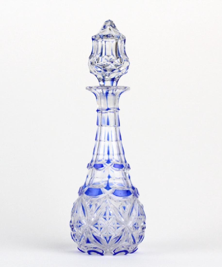 Antique Cobalt Blue Cut To Clear 8" Crystal Cruet: Antique cut crystal cruet with stopper. Features deep, blue to clear, etched patterns with a matching pointed stopper. Measures 8" tall. Good overall condition with some fleabites and fogging to glass