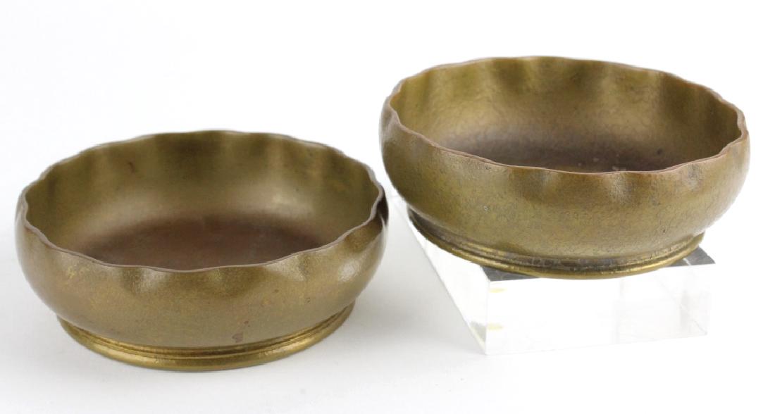 2 x Tiffany Studios Bronze Scalloped Finger Bowls: Two Tiffany Studios New York bronze finger bowls. Crafted of solid bronze. These heavy bowls feature a scalloped rim and textured surface. Both marked Tiffany Studios New York 1713. Measures 4.5" wide