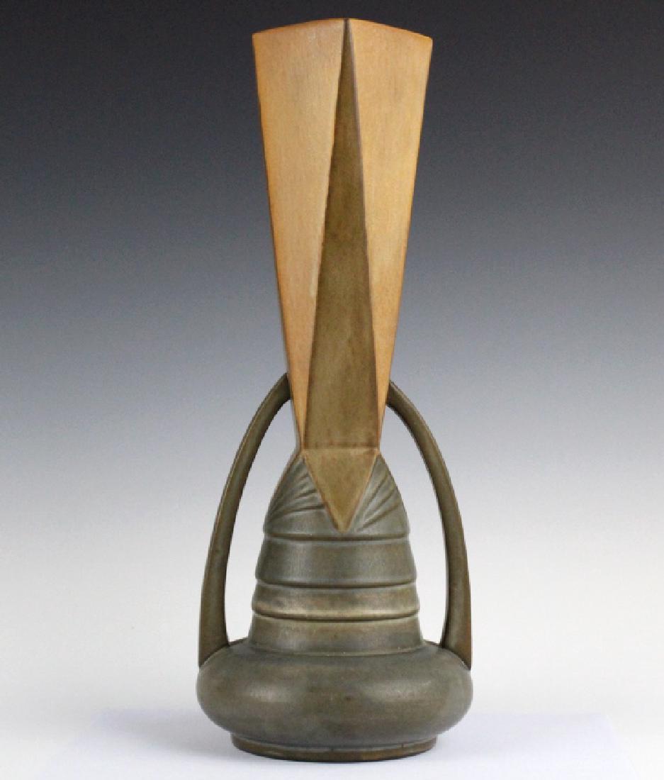Roseville Pottery FUTURA 14" Arches Vase 411-14: Roseville American art pottery Futura arches vase. Features a square neck with tiered body and squat base with double handles going from the neck to the base. Base unsigned. Measures 14.25" tall. Good