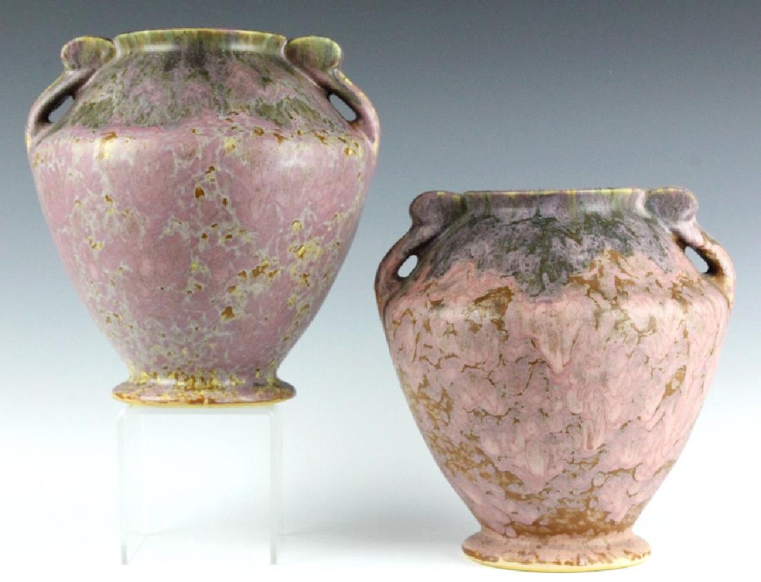 PAIR Roseville Pottery CARNELIAN II 7" Vases 331-7: Two Roseville American art pottery Carnelian II vases. Features a layering of pink and purple glaze on a bulbous body with scrolled handles. Unsigned. Measures 7" tall. Good overall condition with no 