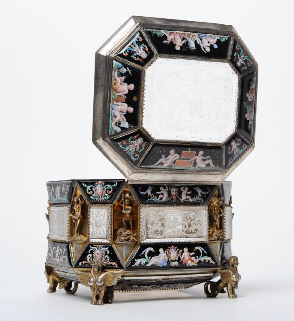 Antique Viennese Rock Crystal Enameled Silver Box: Stunning Renaissance revival style gilt silver box. Ornate design set with windows of carved rock crystal. Intaglio cut with four toed dragon and scroll motif. Surrounded by black panels with figural 