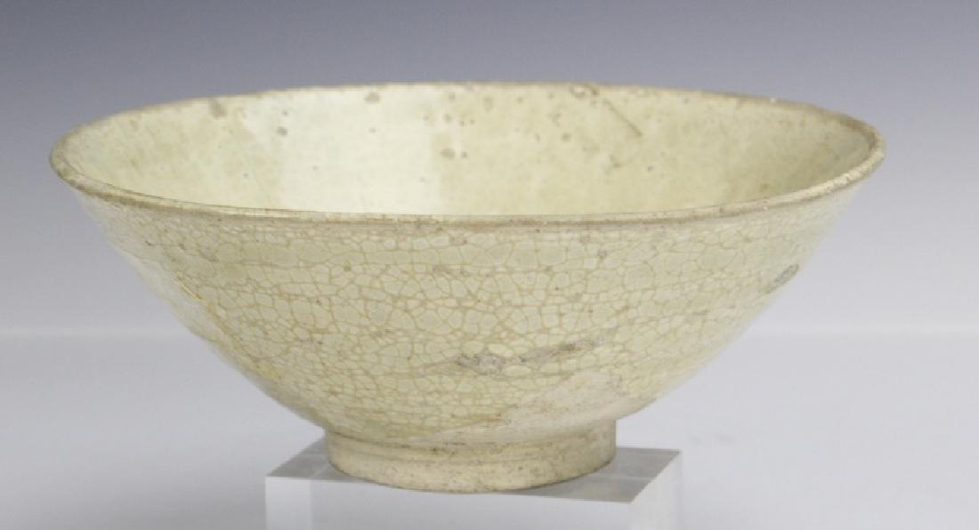 Chinese Provincial Ming Dynasty Glaze Pottery Bowl: Antique Chinese Mind Dynasty bowl. Crafted of earthenware with hand applied cream glaze. Features a provincial design with crackle finish. Measures 2 1/2" x 6 3/8". Fair condition with multiple imperf
