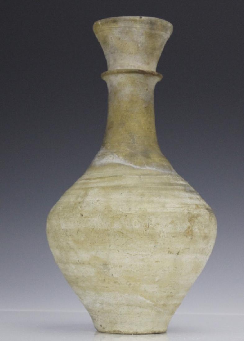Han Dynasty Grey Ware Ringed Neck Pottery Vase: Antique Chinese pottery vase. Crafted of grey ware pottery. Bulbous form with ring neck and flared rim. Measures 10 3/8" x 5 1/2". Minor losses to rim and neck. In house USA domestic shipping $45 plus