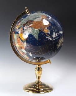 Fine Semi Precious Gemstone Inlaid Desktop Globe: Deep blue oceans inlaid with semi-precious gemstones including jasper, jade, abalone and others. Gold lined latitude and longitude markers. Mounted on a gold finished stand. Measures 21" x 14" Good co