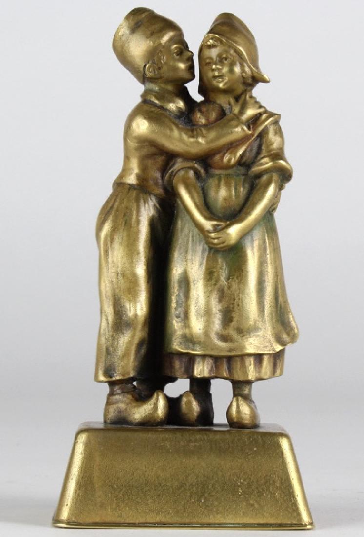 Antique Bronze Statue of Dutch Children Embracing: Crafted of fine quality cast bronze. Features a young couple in a romantic embrace. Unmarked. Measures 5" x 2 1/2". Good condition with mild surface wear. In house USA continental shipping $35 plus in