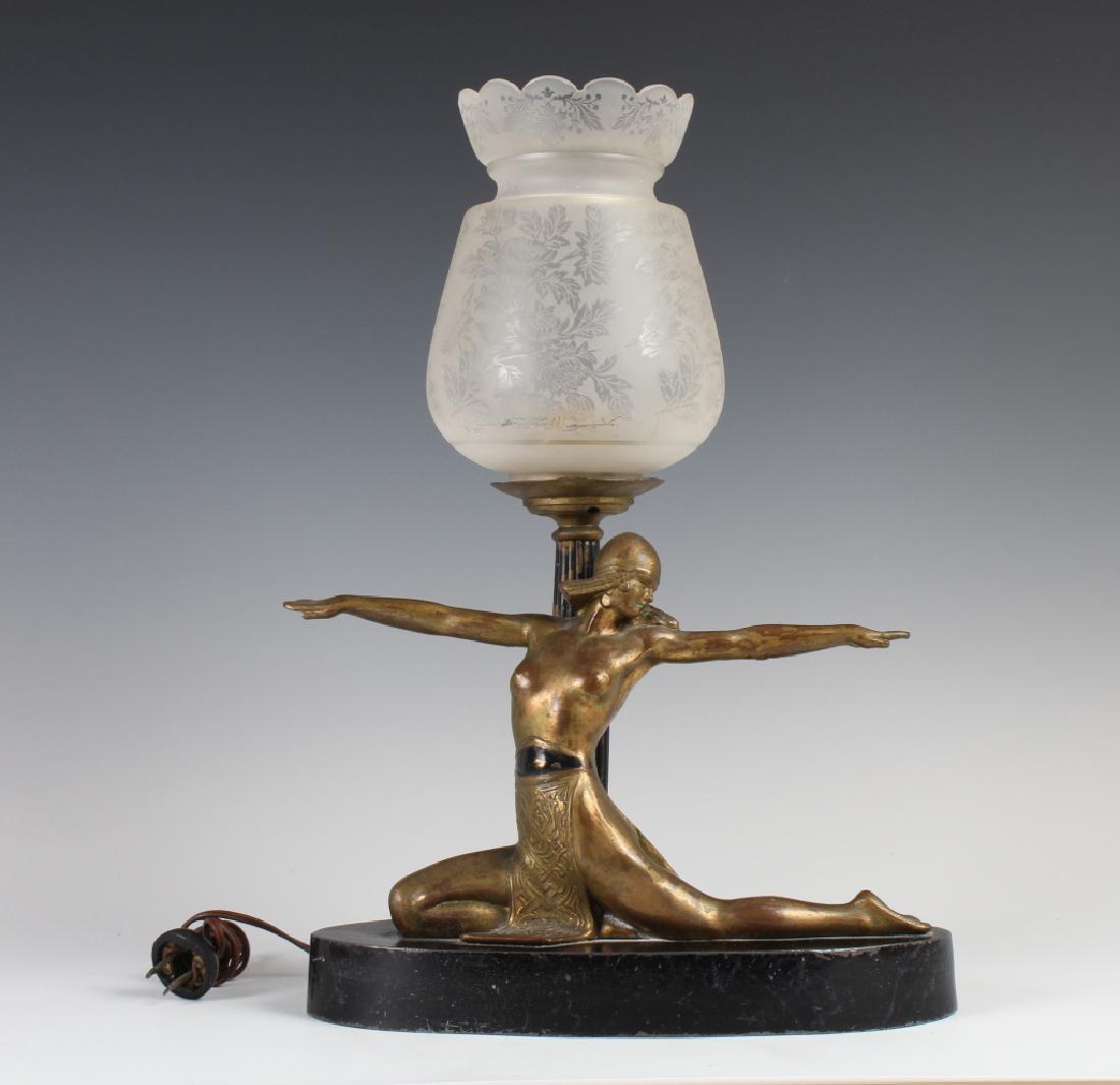 Antique Art Deco Semi Nude Female Metal Table Lamp: Antique art deco era table lamp. Crafted of bronze type metal with etched floral glass shade. Depicts a classic semi nude female dancer on black base. Measures approximately 17" x 12" total. Unknown i