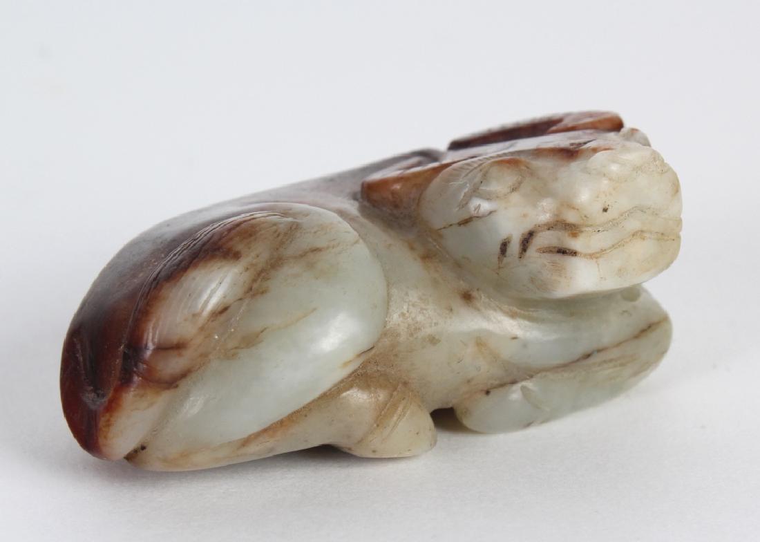 Old Chinese Mutton Fat Jade Carved Bull Ox Figure: Chinese carved jade figurine. Depicts the form of an ox carved from a mutton fat jade. A streak of rust tone jade runs down the back of the animal. No apparent markings. Measures 1 1/4' x 2 3/4" x 1 3