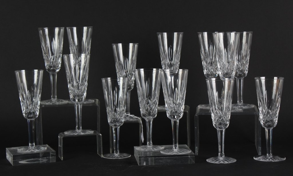14 Waterford Crystal Lismore Champagne Flute Glass: Set of 14 signed Waterford 7 1/4" Lismore cut champagne wine flute glasses. Good overall condition with wear consistent with age. In house Hill Auction Gallery continental USA shipping $85 plus insura