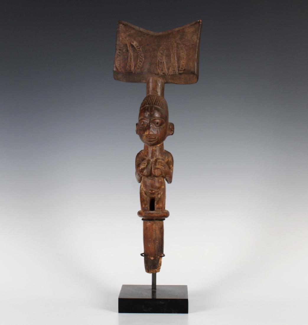 African Yoruba Shango Staff Statue MUSEUM QUALITY: Antique carved wood tribal staff. Thought to be from a Nigerian tribe. Depicts a stylized nude woman, kneeling, with an elaborate headpiece. Comes on a wood stand. No apparent markings. Measures 13 1/