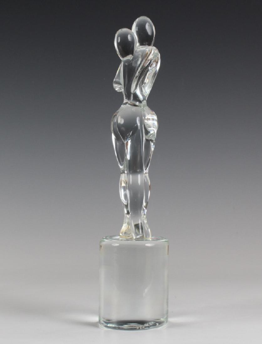 Rossi Murano Italian Art Glass Modernist Sculpture: Signed Rossi mid century modern Murano Italian studio art glass sculpture. Features the form titled Lovers Kiss and depicts two nude figures in an embrace. Measures 14" tall. Signed on base. Good over