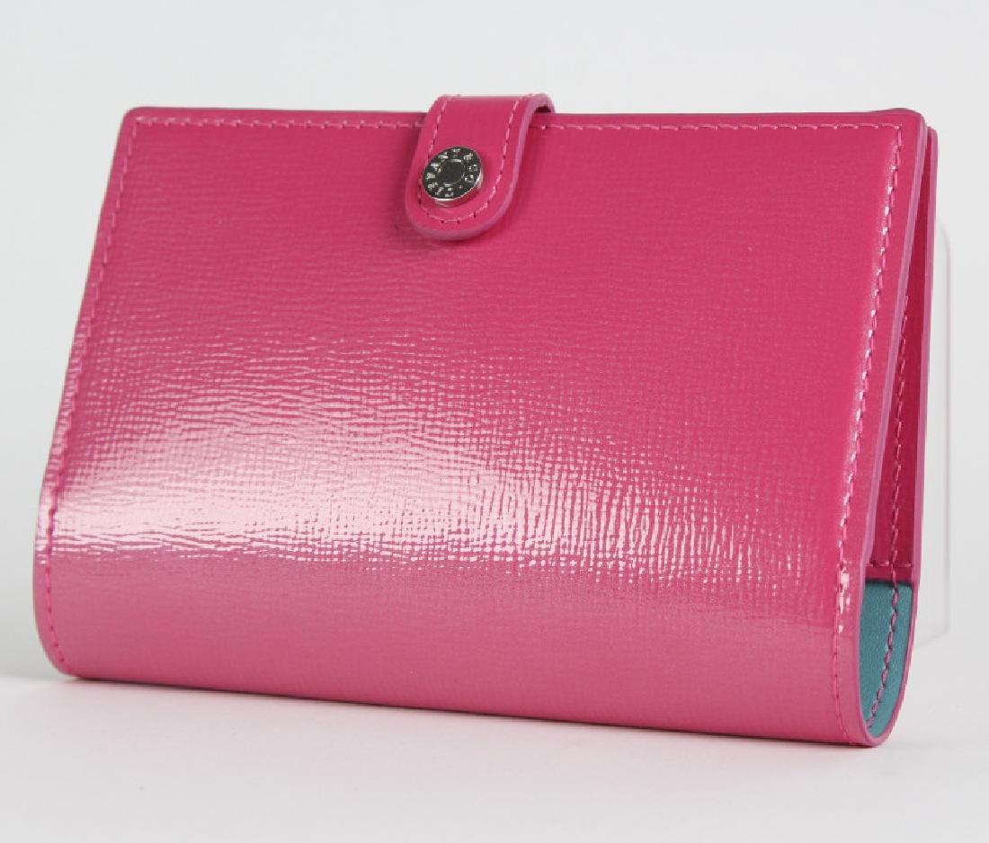 Tiffany & Co Italian Leather Passport Cover Wallet: Crafted from fine quality Italian leather with silver tone hardware accent. Inside features passport holder as well as credit card slot. Bright pink color with Tiffany green lining. Comes with origina