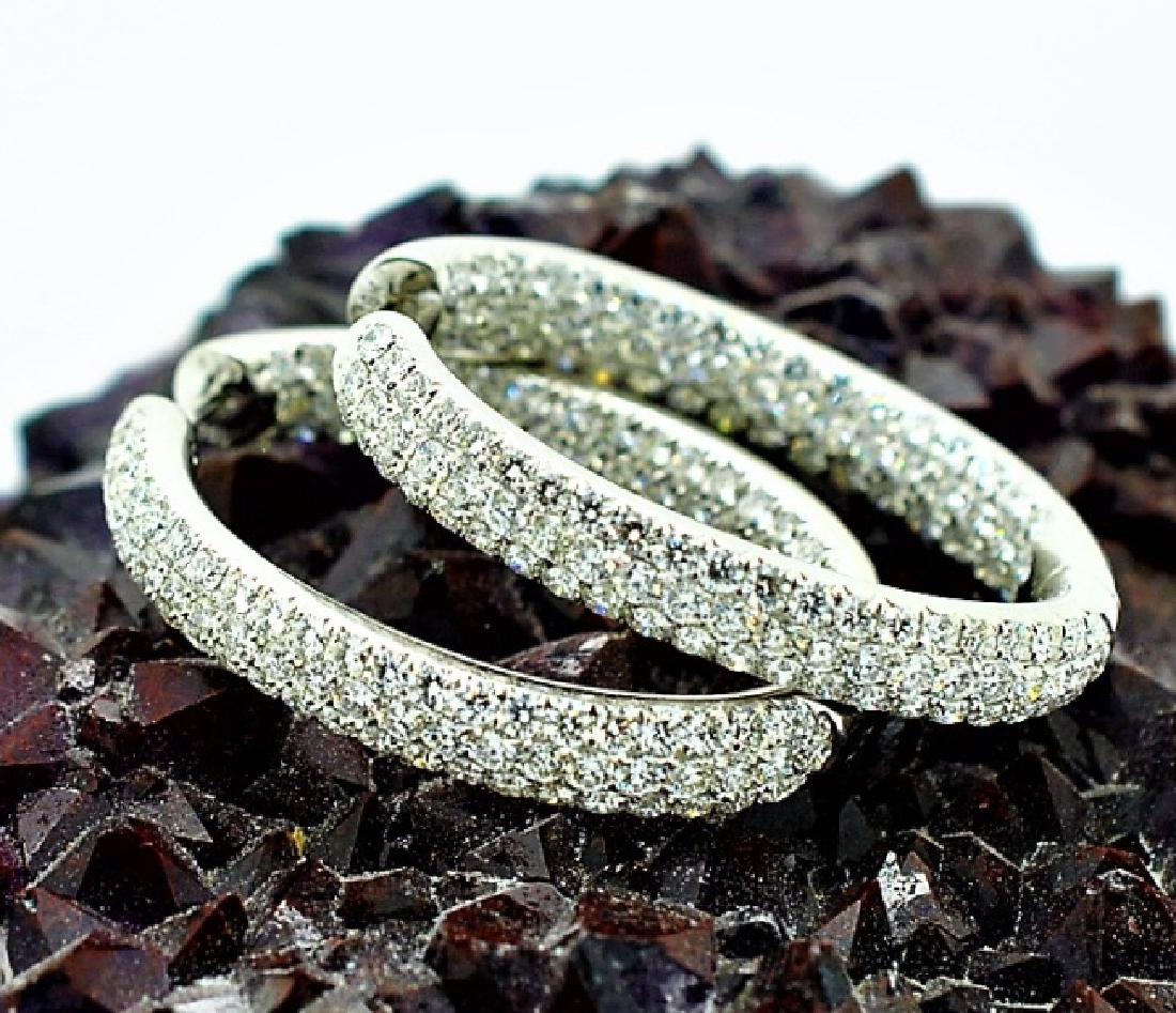 Pair 18K White Gold 6.33 Ct TW Diamond Hoop Earrings: Guaranteed Authentic. Lovely pair of elegant ladies 18k white gold and diamond hoop earrings. Features an ovular hoop measuring 1 1/2" long with three rows of bright white, round brilliant cut, diamon