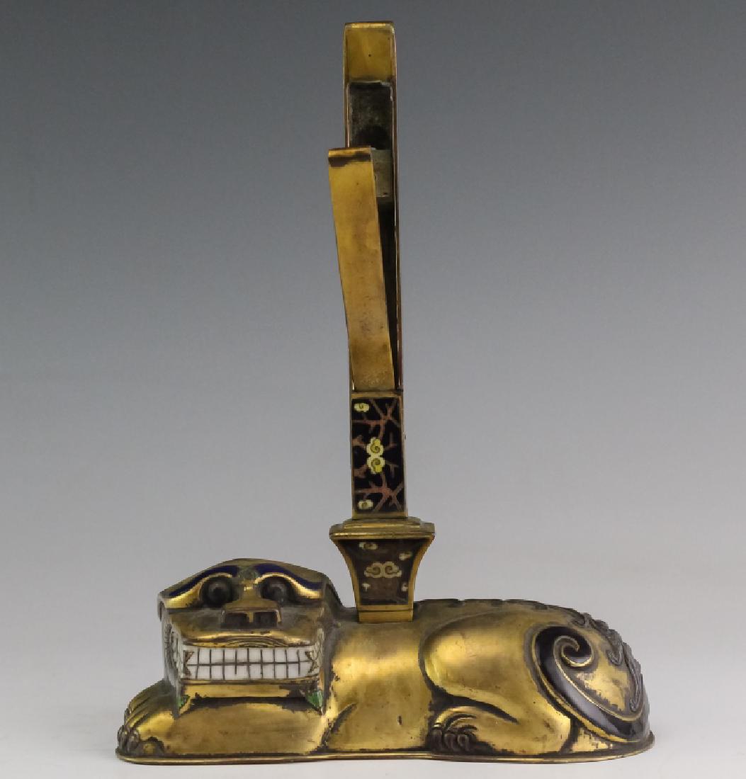 Japanese Antique Meiji Period Enameled Foo Dog: Antique Japanese Meiji period foo dog holder. Crafted of bronze with rich gold gilt finish. Features an archaic form with enameled detailing. Cloud and branch cloisonne detailed holder. Measures 8" x