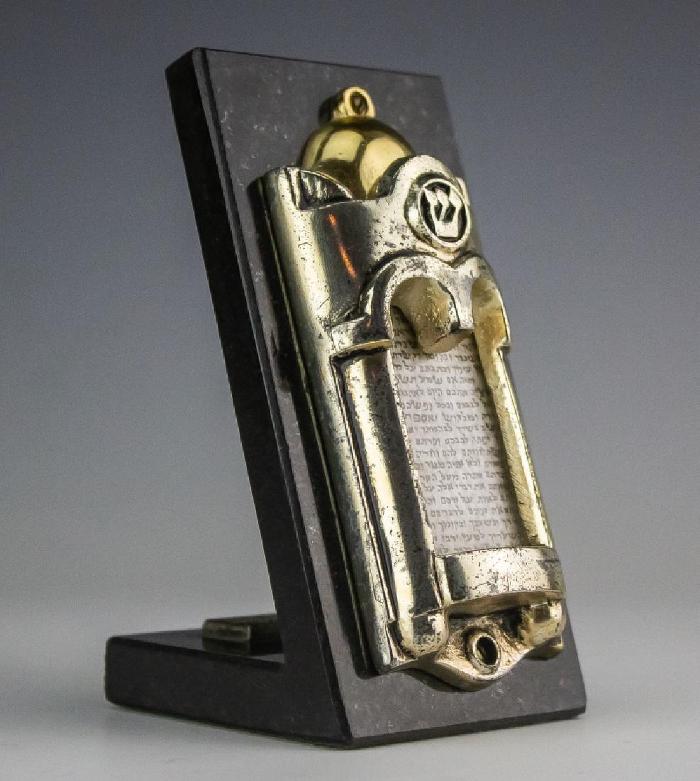 Frank Meisler b.1929 Israel Mezuzah Sculpture: Authentic sculpture by Frank Meisler (1929-Israel). Features open Jewish Mezuzah / scoll. High polished finish with gold highlights. Mounted to a black marble base .Measures approximately 4 1/2" x 3".
