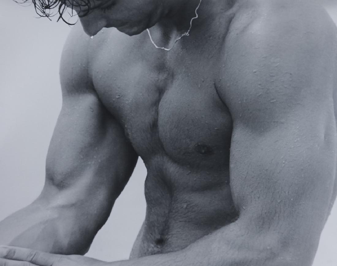 Dianora Niccolini Male Nude Photographic Print: Signed photographic print by Dianora Niccolin (1936- Italian) Depicts a very fit young man in a homoerotic pose. Artist signed on photo verso. Housed in a silver leaf frame with white matting. Work wi