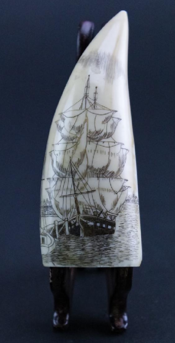 Vintage Scrimshaw Carved Whale Tooth, Docked Ship: Vintage carved scrimshaw whales tooth. Features the image of a tall sail ship drying its sails. Measures 4 3/4" x 1 1/2". Good overall condition with age related wear. Hill Auction Gallery will not sh